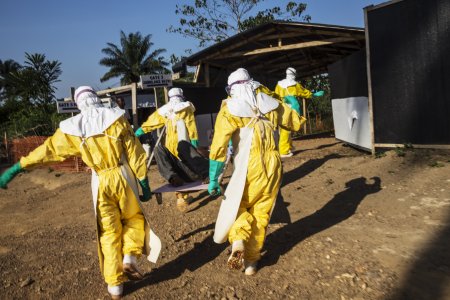 Doctors carry a patient infected by ebola