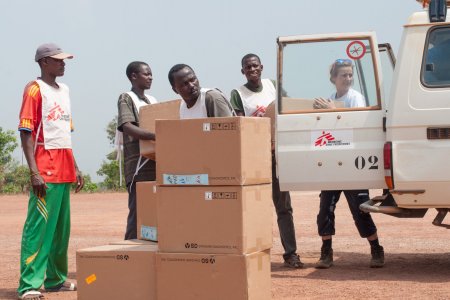 MSF logistician Jennifer Bock and her colleagues unload 58 boxes one ton of medical supplies, mainly malaria testing kits, destined for the MSF-supported health centre in Boguila.