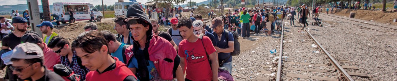 A group of refugees move on as they are told they can cross the border.