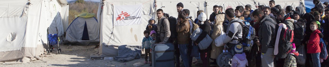 Refugees from Iraq, Afghanistan and Syria wait to cross the border from Greece to Macedonia at Idomeni