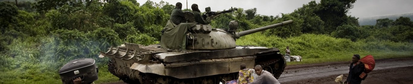 A tank moves towards the frontlines as people are fleeing