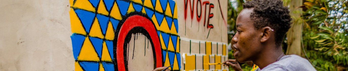 Painting "Tuko Poa" benches in Kibera