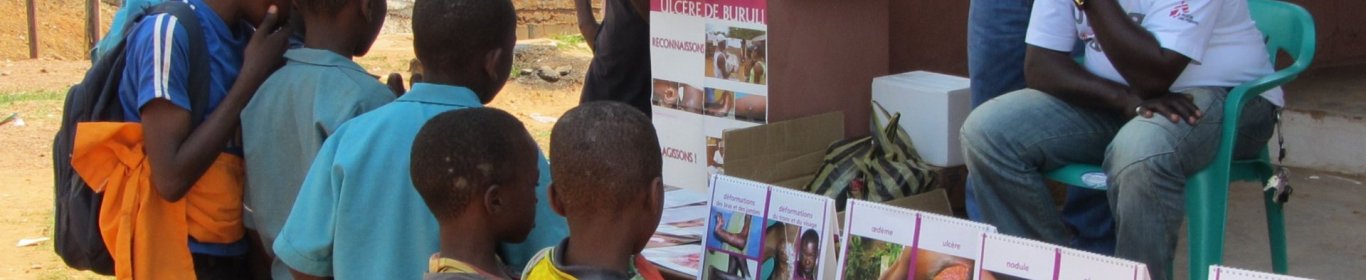 Health worker raising awareness on Buruli Ulcer symptoms. 