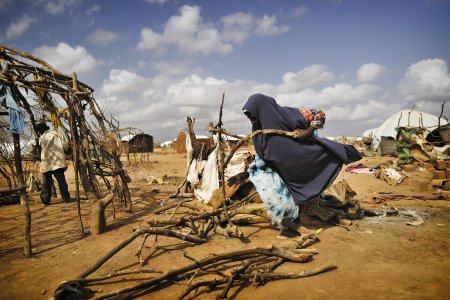 The Poverty of Humanitarian Critique A woman is building a shelter in Dadaab refugee camp