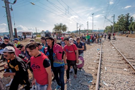 A group of refugees move on as they are told they can cross the border.