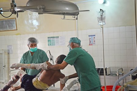 Medical staff prepare a 20-year-old Afghani man for surgery at the MSF supported hospital in Boost, Lashka Ghar, Afghanistan.