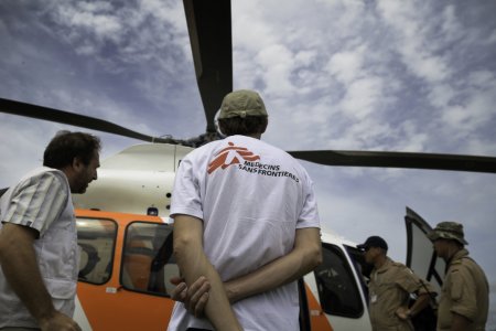 The shared MSF / ICRC helicopter exchanging passengers in Gumuruk. In the rainy season helicopter is the only reliable way to move around Pibor County in South Sudan.