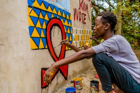 Painting "Tuko Poa" benches in Kibera