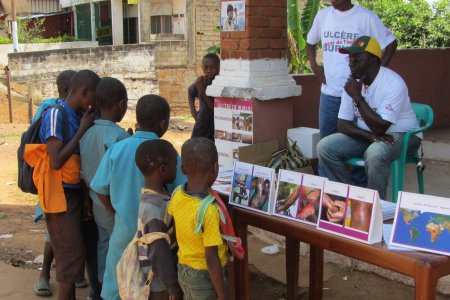 Health worker raising awareness on Buruli Ulcer symptoms. 