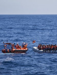 Lifejackets are distributed to 129 people in a rubber boat by an MSF rib in international waters off the north coast of Libya, on June 8, 2017.